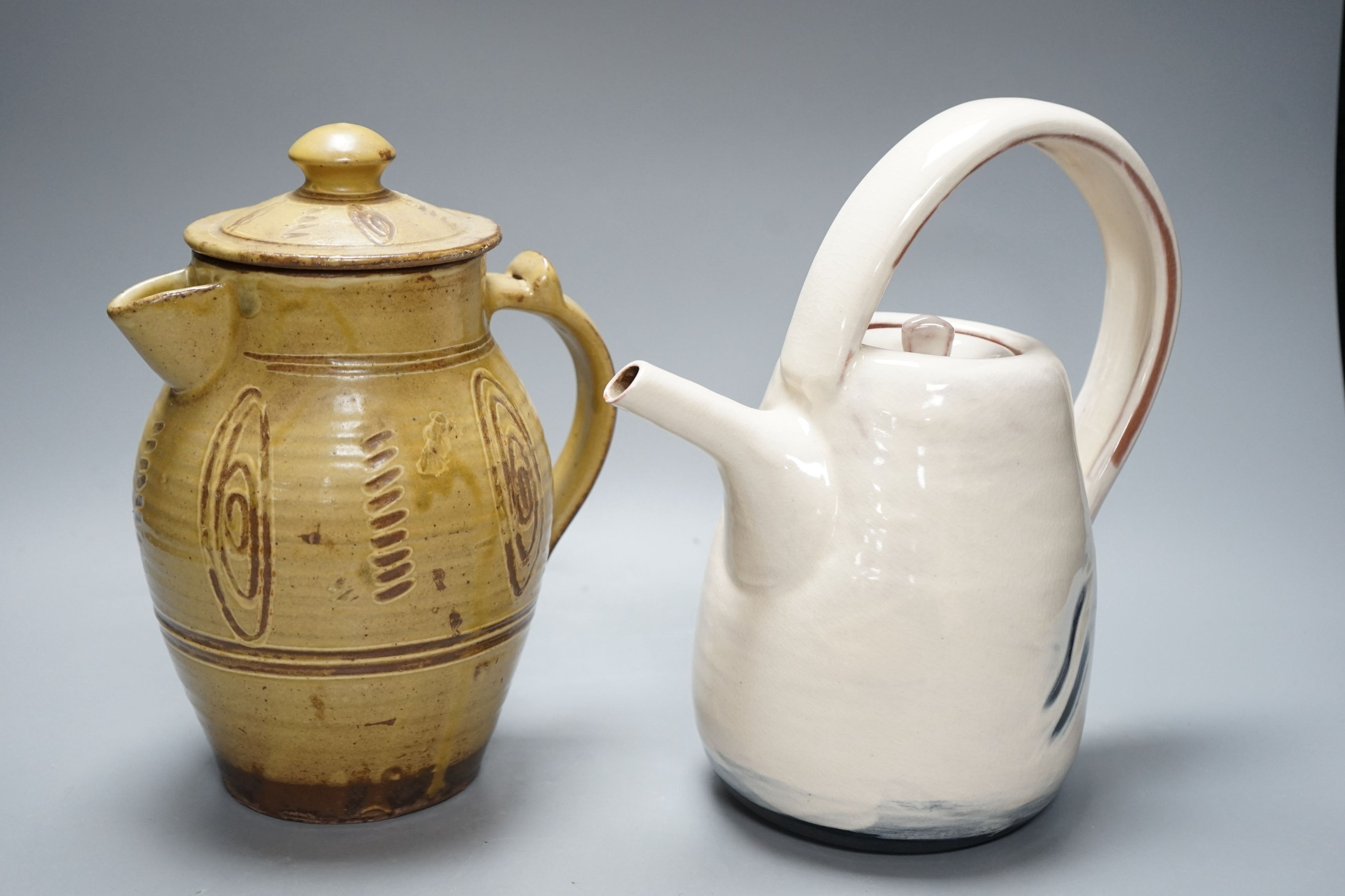 British studio pottery; a Jane Sawyer coffee pot and cover, Danlami Aliyu, for Wenford Bridge Pottery, pale green glazed stone were covered jug, and a black glazed white stoneware teapot, tallest 25cm, (3)